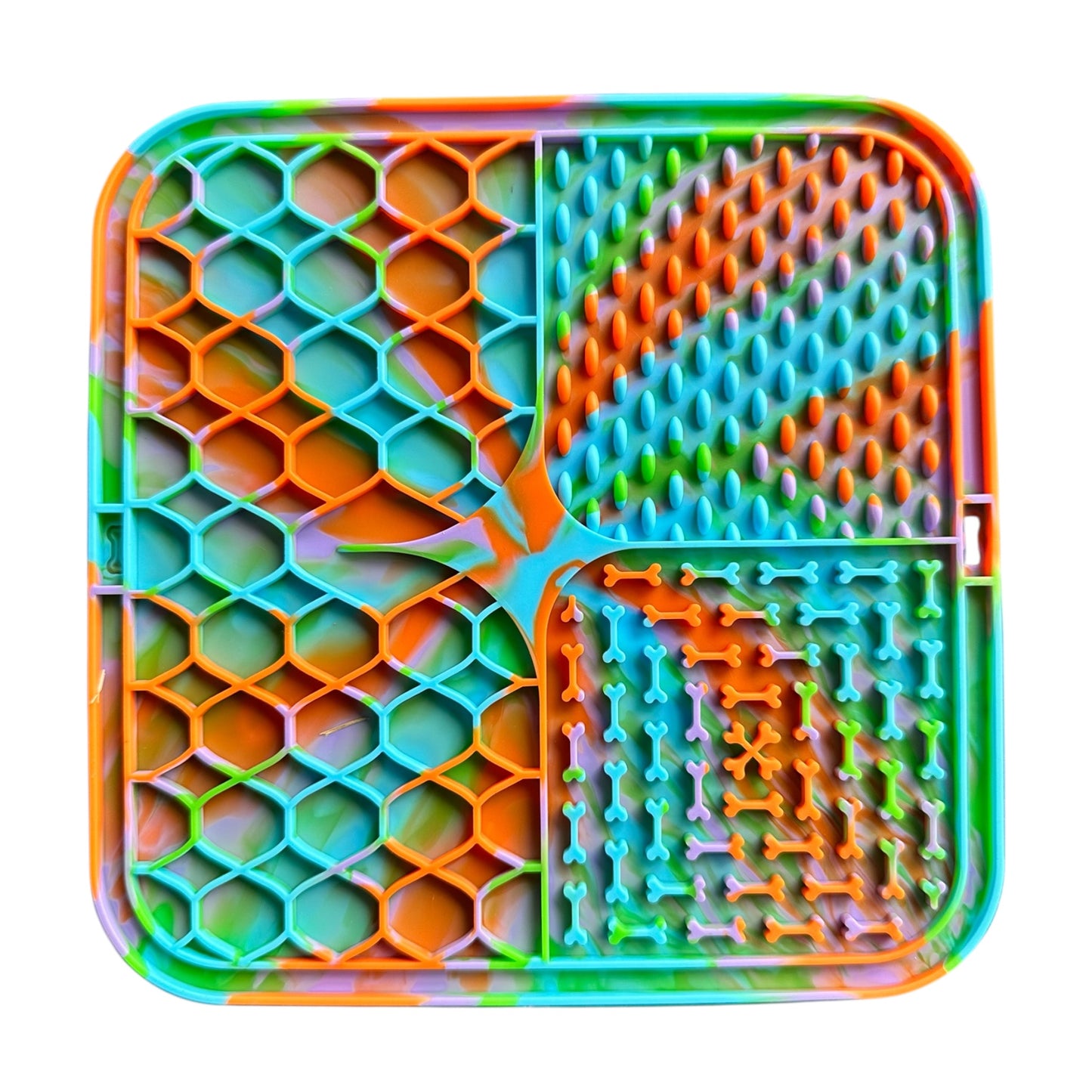 Colorful textured dog lick mat with various patterns on a white background