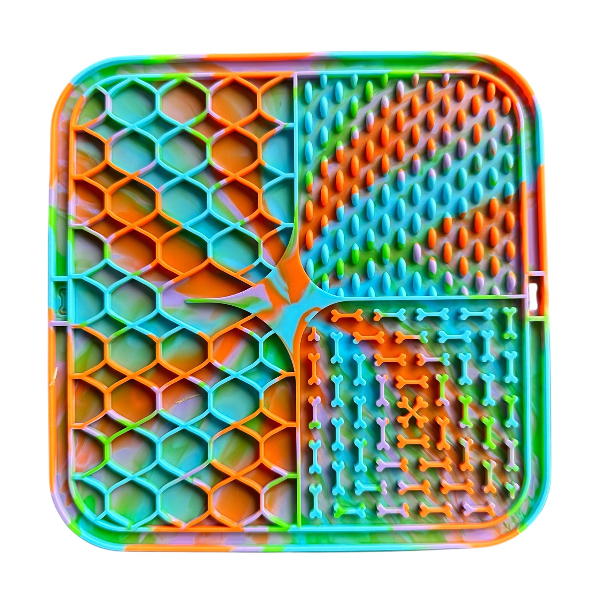 Colorful textured dog lick mat with various patterns on a white background