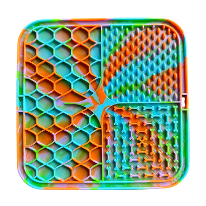 Colorful textured dog lick mat with various patterns on a white background