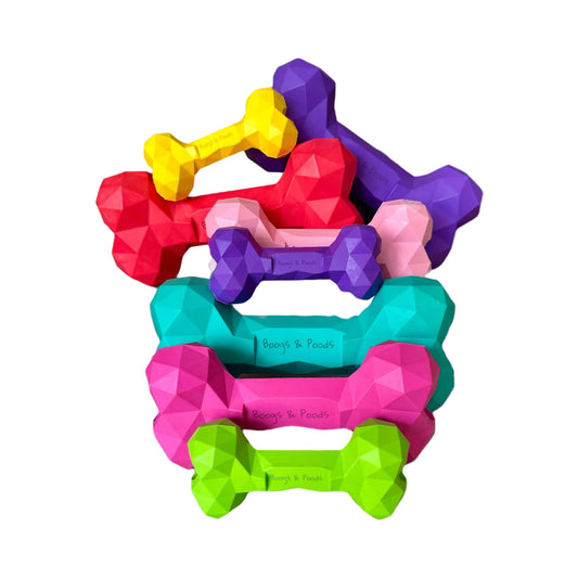 Colorful dog toys shaped like bones on a white background