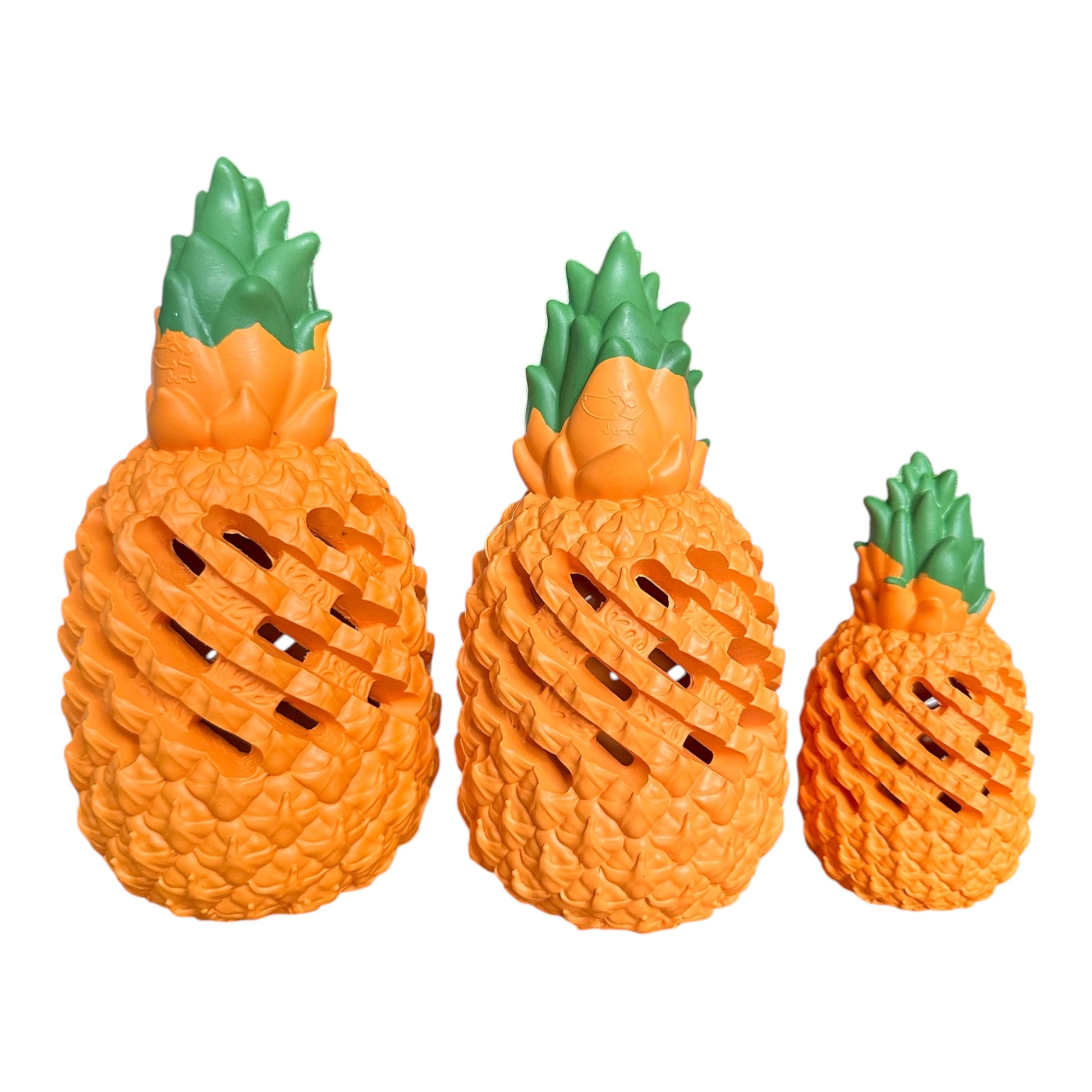 Three pineapple-shaped toys of different sizes on a white background