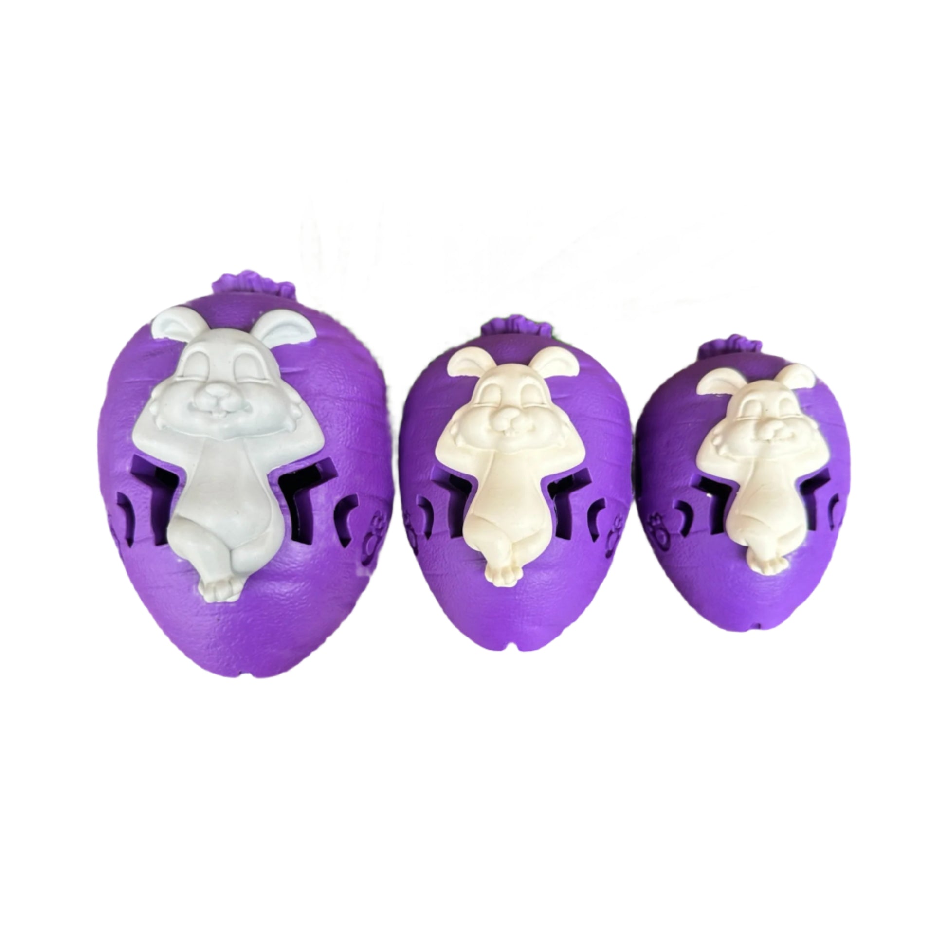 Three purple rubber carrot dog toys with white rabbits. 