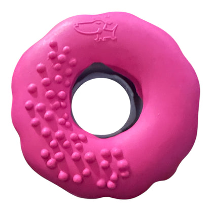 Pink doughnut shaped rubber toy for dogs and puppies who are vigorous chewers.
